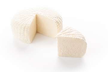 Sulguni cheese. A piece of triangular shape is cut out. Isolated on a white background.