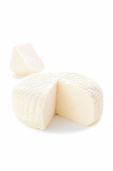 Sulguni cheese. A piece of triangular shape is cut out. A piece in the background. Isolated on a white background.