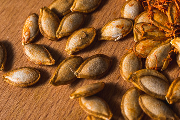  healthy pumpkin with seeds cut into slices and cubes for baking and eating. Delicious vegetarian food. Many vitamins and substances.