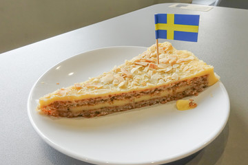 Piece of delicious sweet pear tart on white plate
