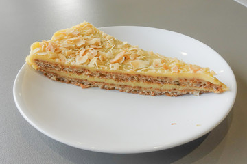 Piece of delicious sweet pear tart on white plate