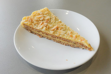 Piece of delicious sweet pear tart on white plate