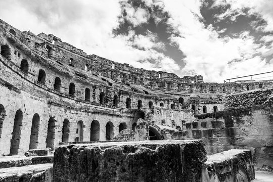 Old antique amazing well conserved huge Amphitheatre of El Jem in Tunisia. Horizontal black and white color photography.