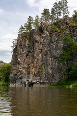 Fototapeta na wymiar rocky riverbank. Steep high cliffs and the river