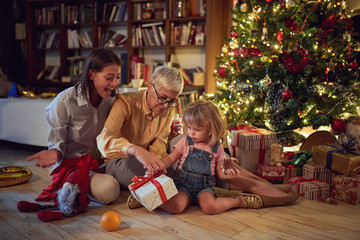 Happy family with gifts celebrating Christmas