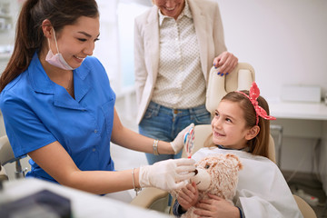 Dentist giving lollipop to child