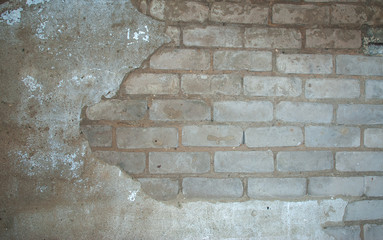 texture of old white brick wall with remnants of plaster