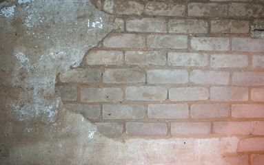 texture of old white brick wall with remnants of plaster