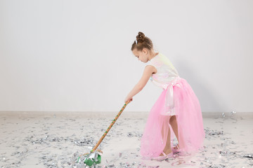 Pretty female child cleaning apartment after christmas party