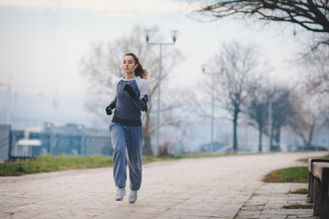 Young woman outdoors running