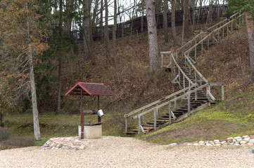 water well on the background of a high wooden staircase.