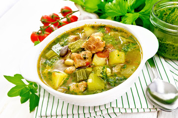 Soup with pisto sauce in bowl on board