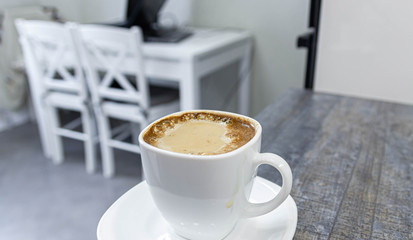 morning coffee with milk on a background of white kitchen interior.