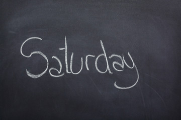 Day of the week written on a blackboard with white chalk, saturday