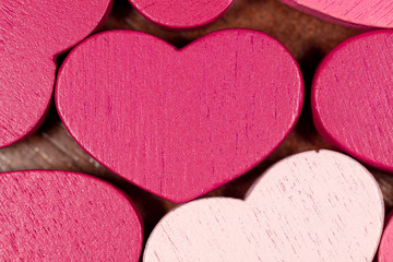 Pink wooden hearts as a background