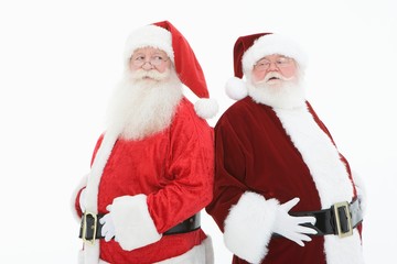 Two Santa Claus Standing Back To Back