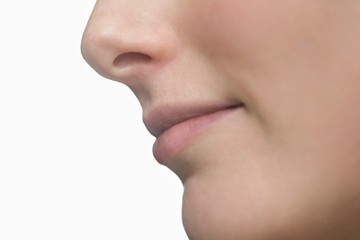 Obraz premium Woman's Lips And Nose Against White Background