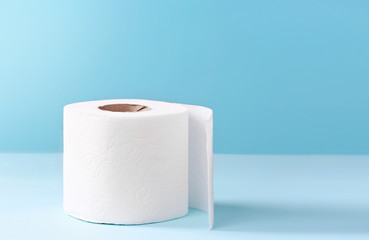 Toilet paper white roll on blue background.