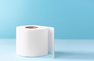 Toilet paper white roll on blue background.