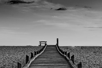 Boardwalk on bleak dramatic beach