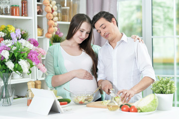Close up portrait of happy husband and wife cooking together in the kitchen
