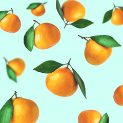Tangerines of different shapes with leaf on a colored background isolated. Tangerines flying in the air. Christmas composition of a tangerines orange with leaves.
