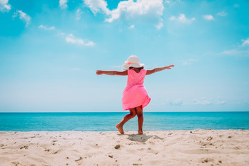 happy little girl dance play on tropical beach