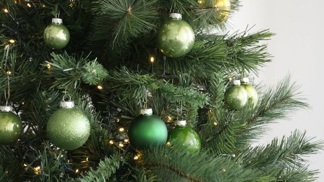 Christmas tree arranged with electric lights on string and colorful baubles 4K footage