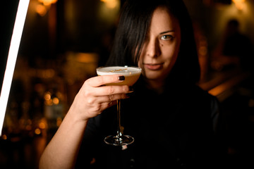 Portrait of a female bartender with a cocktail