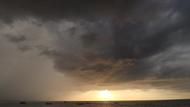 Timelapse video of rain and clouds over ocean and beach 