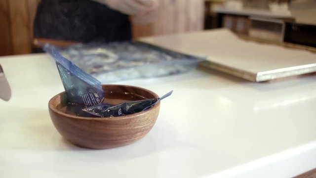 Defrosting food in hot water. Stock footage. Cook unfreezing food in a bag in hot water