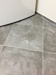 Domestic kitchen clean tiled floor with refrigerator