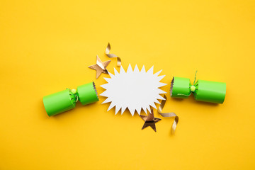 Popped Christmas crackers on a yellow background
