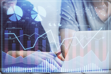 Forex graph with businessman typing on computer in office on background. Concept of analysis. Double exposure.