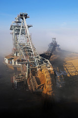 A huge bucket-wheel excavator on the open-pit mine. Excavator in the fog.