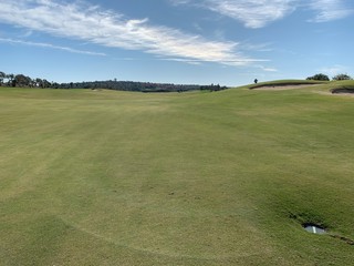 Fototapeta premium golf course fairway and bunkers with blue sky