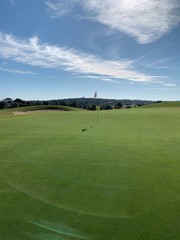 Fototapeta premium golf course with blue sky and white clouds
