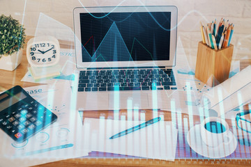 Financial chart drawing and table with computer on background. Double exposure. Concept of...
