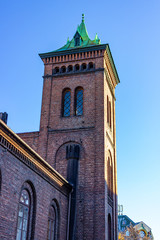 Fototapeta na wymiar Tower of the historical Brannvakten (firehouse) next to the Oslo Cathedral, Oslo, Norway