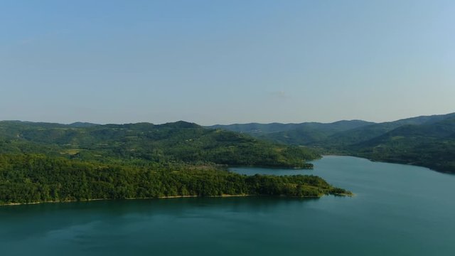 Lake Butoniga water reservoir dam in Croatia pan left panorama, Aerial drone left reveal shot