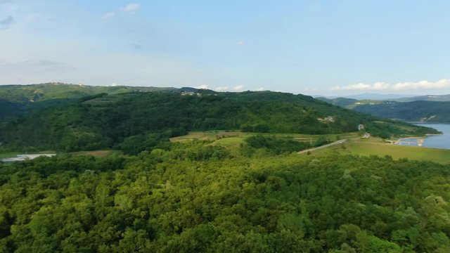 Lake Butoniga water reservoir in Croatia high altitude panorama with wide angle aerial drone reveal shot