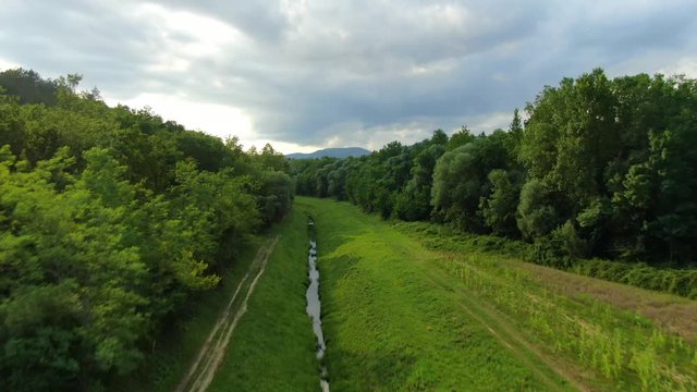Lake Butoniga Croatia water canal tributary system trench going up a hill , Aerial drone flyover pedestal lift shot