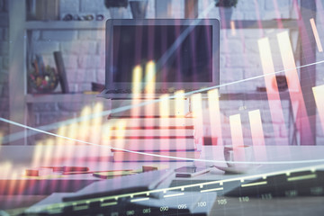 Stock market chart hologram drawn on personal computer background. Double exposure. Concept of investment.