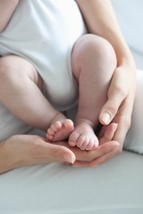 Mother Holding Baby Boy's Feet