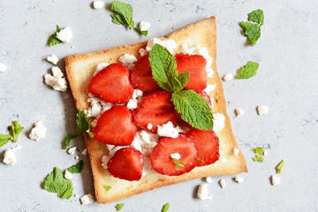 Toast with fruit strawberry, mint and cottage cheese for breakfast. Healthy breakfast, Ruddy bread...
