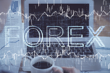 Double exposure of forex graph and work space with computer. Concept of international online trading.