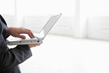 Businesswoman Using Laptop In Warehouse