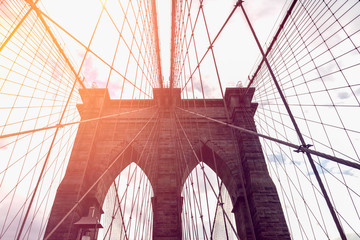 Obraz premium Details of the Brooklyn Bridge in New York City, USA. Toned image with sun light leak