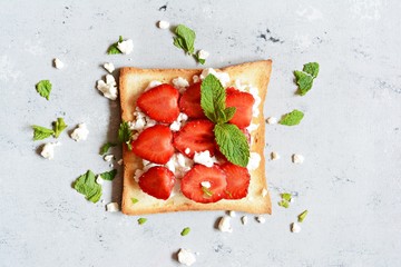 Toast with fruit strawberry, mint and cottage cheese for breakfast. Healthy breakfast, Ruddy bread...