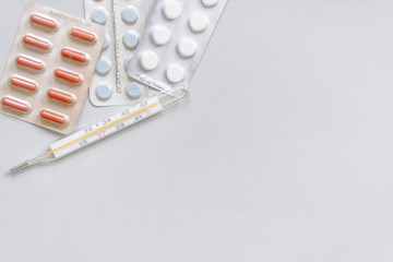 Tablets in packs. Tablets on a light background. Different types of pills